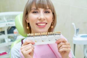 happy woman customer in dentistry , teeth whitening photo