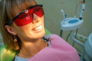 dentistry happy patient in the chair in goggles photo