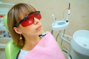 dentistry happy patient in the chair in goggles photo