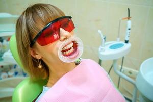 dentistry happy patient in the chair in goggles photo