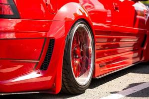 Red sports tuned car rear view of the wheel, close-up . photo