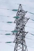 High-voltage tower with cloudy sky background. photo