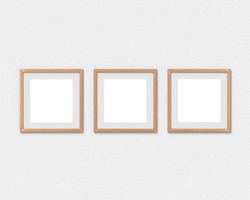 Set of 3 square wooden frames mockup with a border hanging on the wall. Empty base for picture or text. 3D rendering. photo