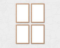 Set of 4 vertical wooden frames mockup with a border hanging on the wall. Empty base for picture or text. 3D rendering. photo