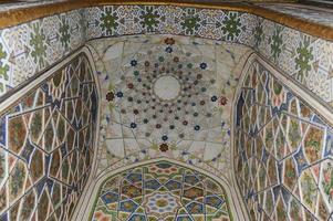 Elements of ancient architecture of Central Asia. Ceiling in the form of a dome in a traditional ancient Asian mosaic photo