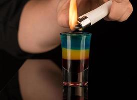 shot glass with alcohol on a dark background photo