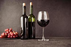 Red wine with bunch of grapes photo