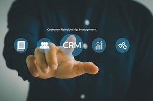 Hand touching CRM  Customer relationship management automation system software.business technology on virtual screen concept. photo