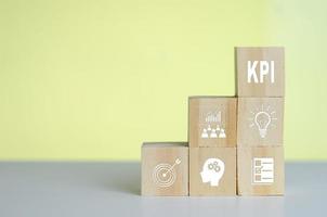 Wooden cubes with KPI Key Performance Indicator symbol on background and copy space.Business concepts. photo