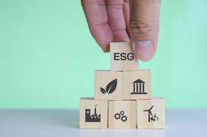 Wooden cubes with ESG Environmental social and governance symbol on background and copy space.Business concepts. photo