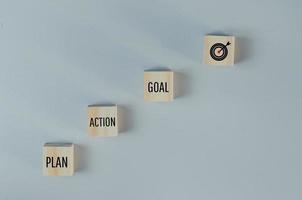 Wooden cubes with plan action goal symbol on background and copy space.Business concepts. photo