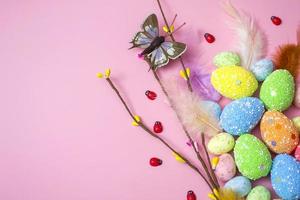 Easter background with Easter eggs and spring flowers on a pink background. flat lay, top view. photo