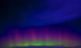 colorful aurora sky with some clouds surface abstract flow thunder clouds in the sky on dark blue sky. photo