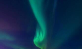 colorful aurora sky with some clouds surface abstract flow thunder clouds in the sky on dark blue sky. photo