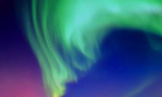 colorful aurora sky with some clouds surface abstract flow thunder clouds in the sky on dark blue sky. photo