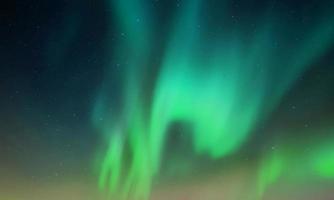 colorful aurora sky with some clouds surface abstract flow thunder clouds in the sky on dark blue sky. photo