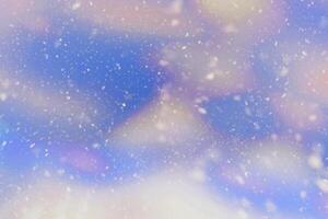 abstract natural light blue winter christmas sky heavy white snowflakes falling shining beautiful snow on sky white. photo