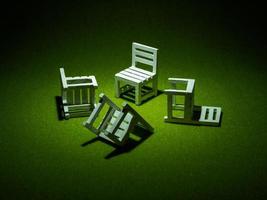 White wooden chairs on artificial grass. Light shining down from above In the dark tone low key photo