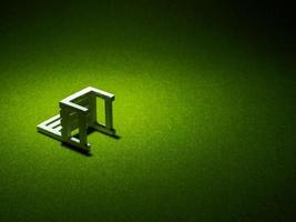 White wooden chair on artificial grass. Light shining down from above in the dark tone low key photo