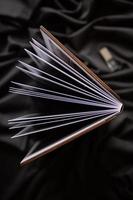 Wooden book with a nameplate on a black fabric background. photo