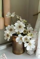 Flowers in an iron vase for home decor. photo