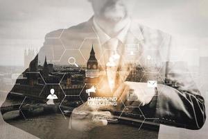 Double exposure of success businessman holding neck tie with London building,Oxford,front view,filter effect photo