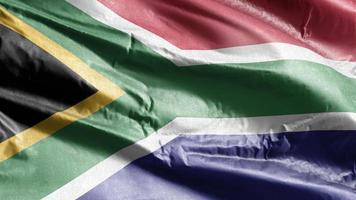 bandera textil de sudáfrica ondeando en el bucle de viento. bandera sudafricana meciéndose en la brisa. tejido textil tejido. fondo de relleno completo. Bucle de 10 segundos. video