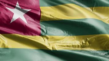 Togo flag waving on the wind loop. Togo banner swaying on the breeze. Full filling background. 10 seconds loop. video