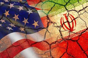 Concept of Conflict between USA and Iran war - US America and Iran flags on split up dried cracked earth soil ground photo