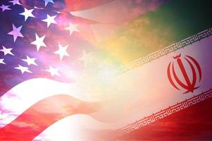 Concept of Conflict between USA and Iran war - US America and Iran flags on red cloud sky sunset background photo