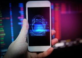 Data security systems on mobile phone with locked padlock for protect crime by an anonymous hacker - technology background cyber security on smartphone hand concept photo