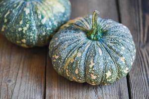 green pumpkin food on wooden background, fresh Asian Thai pumpkin frome the garden for cooked food or dessert photo