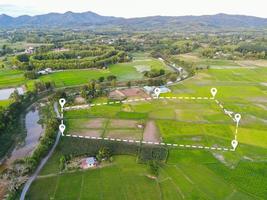 Land plot in aerial view, Top view land green field agriculture plant with pins, pin location icon for housing subdivision residential development owned sale rent buy or investment countryside suburbs photo