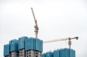 On cloudy days, high-altitude boom on high-rise buildings in modern cities under construction photo