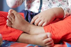 child girl suffering from itching skin, close up. photo