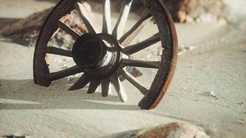 Large wooden wheel in the sand video