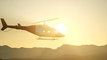 extreme slow motion flying helicopter and sunset sky video