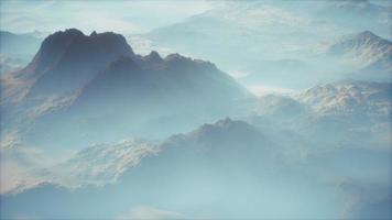 Distant mountain range and thin layer of fog on the valleys video