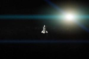 Space shuttle in outer space in a front of te Sun wit lens flare. Elements of this image were furnished by NASA. photo