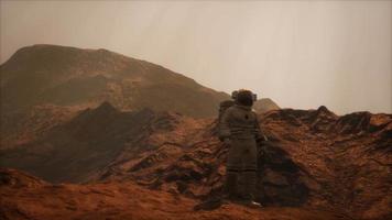 Spaceman walks on the red planet Mars. Space Mission video