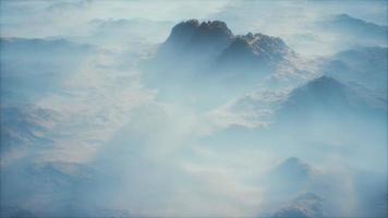 Distant mountain range and thin layer of fog on the valleys video