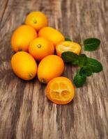 Kumquats on a wooden table photo