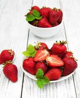 ripe strawberries on wooden table photo