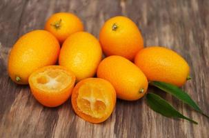 Kumquats on a wooden table photo