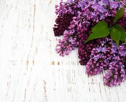 Lilac flowers on table photo