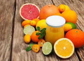 Jar of juice and fresh citrus fruits photo