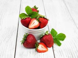 ripe strawberries on wooden table photo