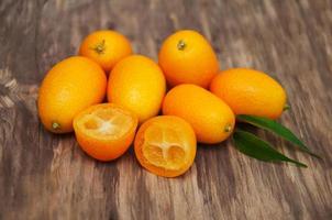 Kumquats on a wooden table photo