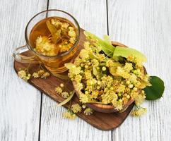 cup of herbal tea with linden flowers photo