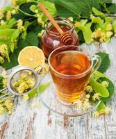 cup of herbal tea with linden flowers photo